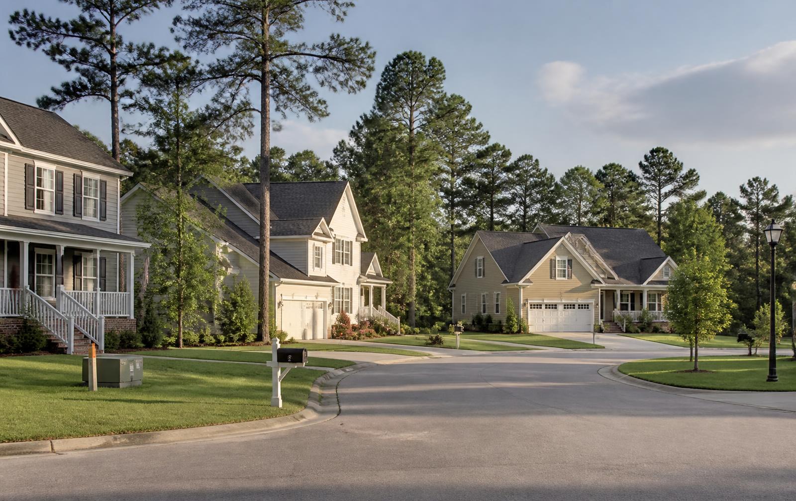 Chesapeake suburban cul-de-sac with wide green lawns, tall pines, and single-family homes